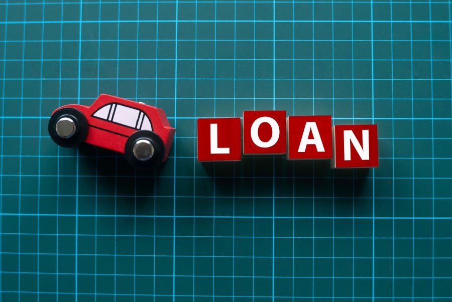 Car loan concept with toy car and blocks