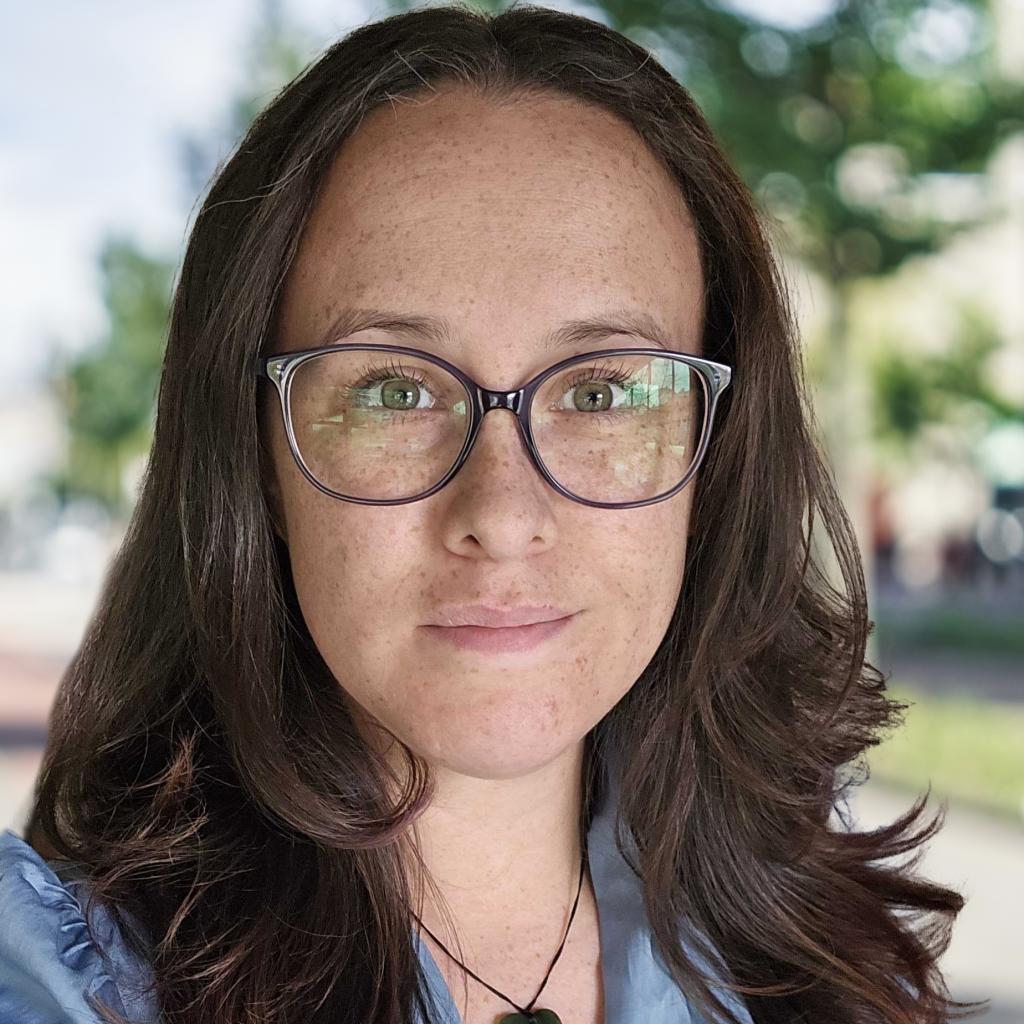 Woman with glasses outdoors.