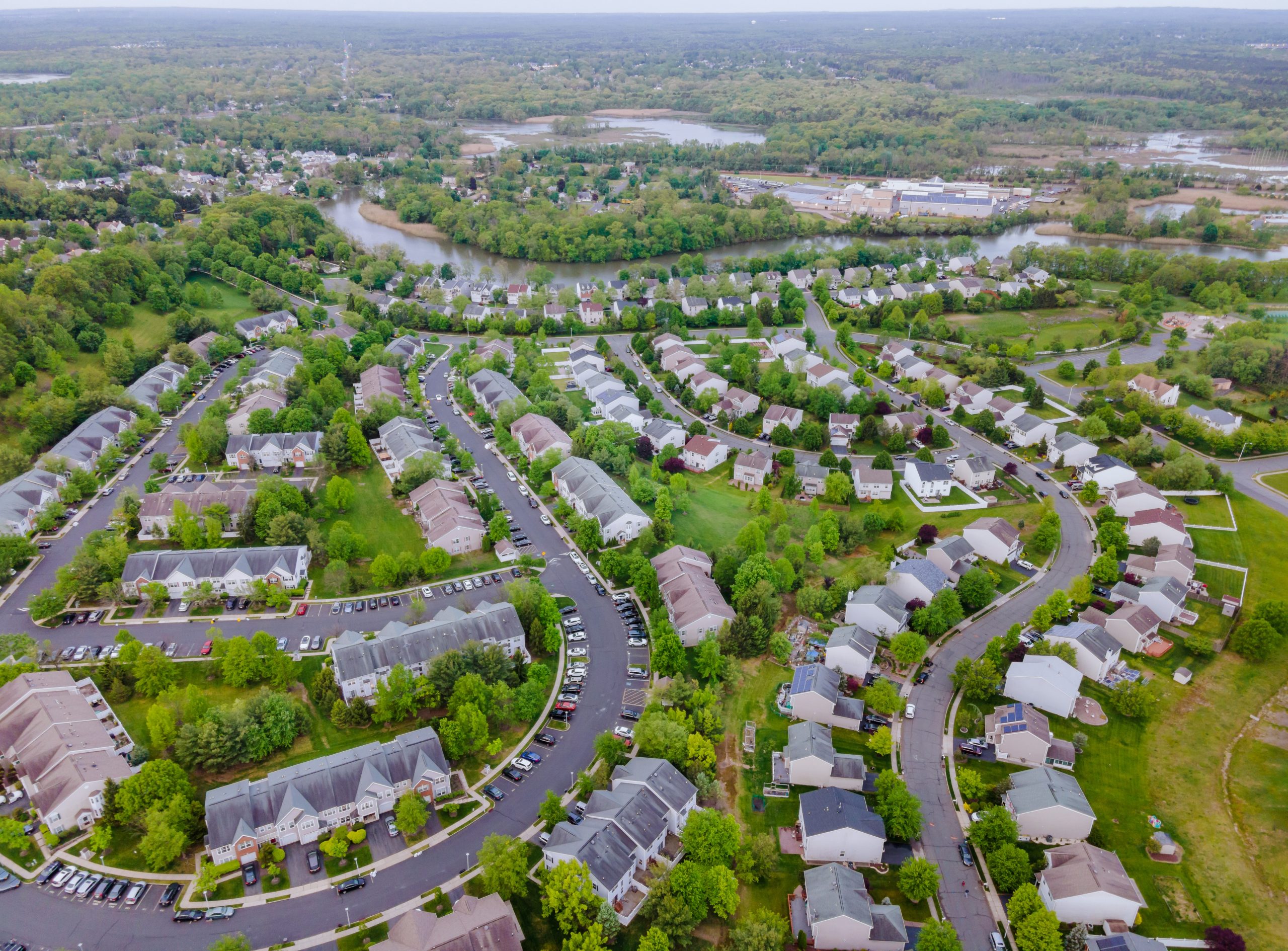 Aerial view of suburban neighborhood with green areas.