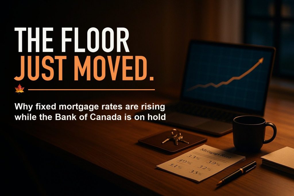 Editorial cover: a dim modern home office at dusk with a laptop screen showing a rising yield curve, keys and a mortgage rate quote on the desk. Headline reads THE FLOOR JUST MOVED. Subline: Why fixed mortgage rates are rising while the Bank of Canada is on hold.